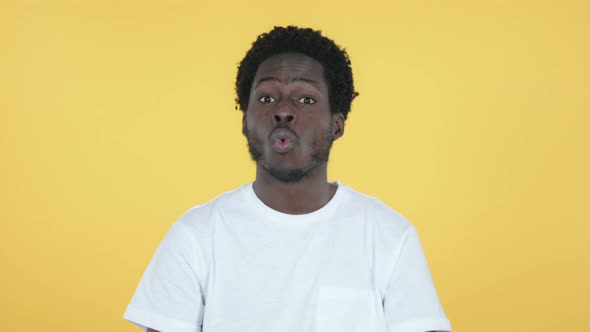 Shocked African Man Surprised By Wonder, Yellow Background