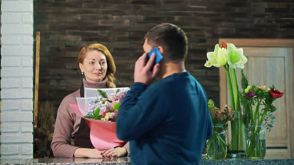 A man takes a bouquet