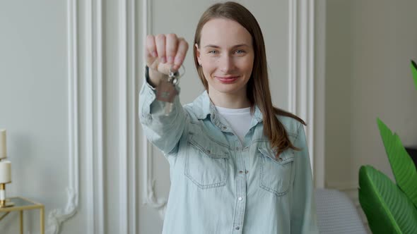 Happy Woman Apartment Owner with Keys Looking at Camera