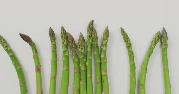 Video of fresh asparagus over white background