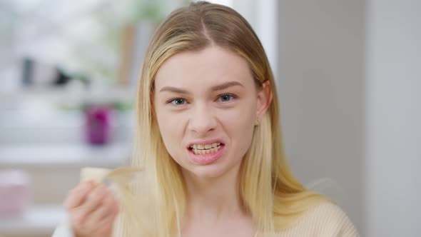 Portrait of Stressed Angry Frustrated Woman Taking Off Tape From Mouth and Screaming Looking at