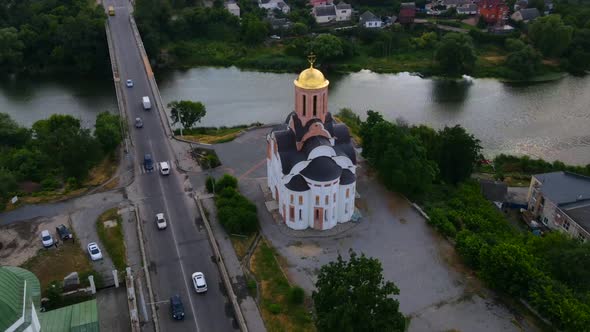 Aerial Timelapse of Two Small Churches and Bridge Over River in Small European City. Kyiv Region