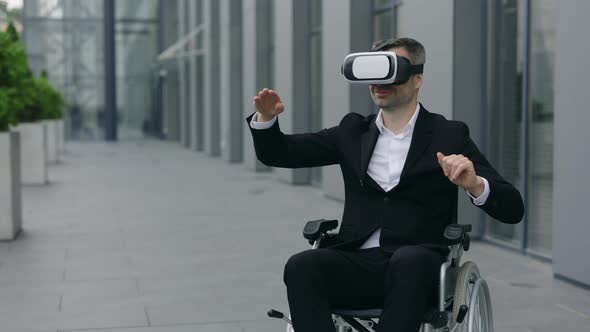 Crop View of Male Ceo Executive on Wheel Chair Wearing Virtual Reality Googles Moving Hands