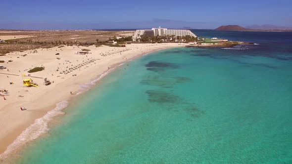 Aerial view of white sand and turquoise water beach in Fuerteventura.