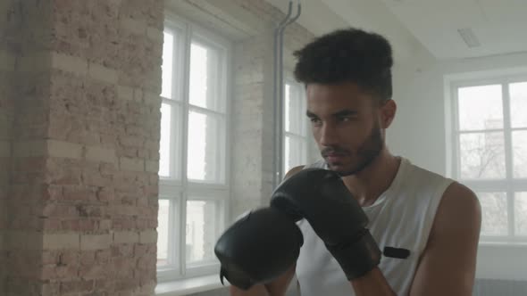 Determined Afro-American Boxer Doing Punches Exercise