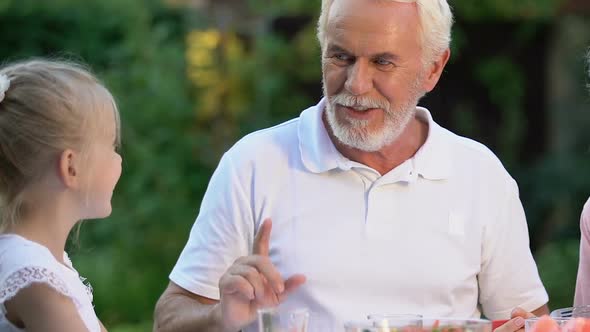 Joyful Grandparents Having Dinner With Grandkids, Family Enjoying Time Together