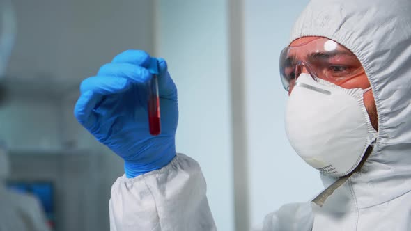 Scientist Coverall Examining Blood Test Tubes Laboratory