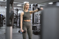 Adult caucasian woman training with weights at the gym - PhotoDune Item for Sale