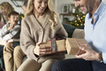 Multi generation caucasian family opening Christmas presents at home - PhotoDune Item for Sale