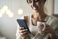 Close up of woman with cup and mobile phone in Christmas time - PhotoDune Item for Sale