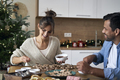 Multi ethnicity couple decorating sweet cookies at home during the Christmas - PhotoDune Item for Sale