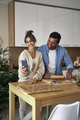 Happy couple has video call from kitchen when baking a Christmas cookies - PhotoDune Item for Sale