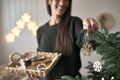 Caucasian woman decorating Christmas tree at home - PhotoDune Item for Sale