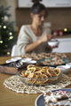 Christmas decorations at the table with woman in background at home - PhotoDune Item for Sale