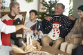 Multi generation caucasian family opening Christmas presents with ugly jumpers - PhotoDune Item for Sale