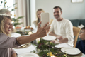 Caucasian family of different generation taking selfie over Christmas table - PhotoDune Item for Sale