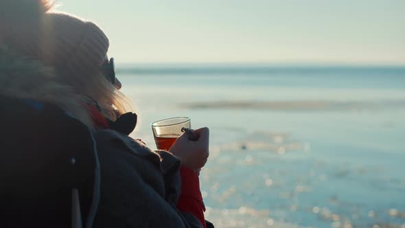 Woman Pouring Tea Into Cup. Hot Coffee From Thermos. Holiday Vacation Trip And Relaxing Moment.