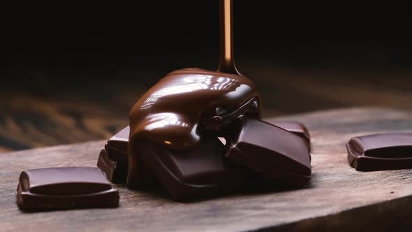 Chocolate Pouring on Chocolate Bars on Black Background