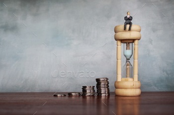 t concept. Businessman sit on hourglass with stack of coins. Copy space for text