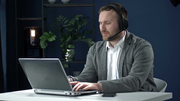 Portrait of a Middleaged Man Working at a Laptop