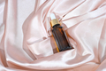 amber glass dropper bottle with cosmetic product on a satin or silk background. - PhotoDune Item for Sale