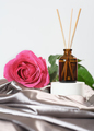 home aroma diffuser with reed sticks, rose flower scent. romantic ambience,  satin bedding sheets.  - PhotoDune Item for Sale