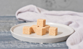 unrefined brown cane sugar cubes on cement plate. stack of natural sweetener for healthy meal - PhotoDune Item for Sale