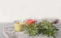 winter holiday ambient still life. glowing soy wax candles in glass pots and pine tree needles.  - PhotoDune Item for Sale