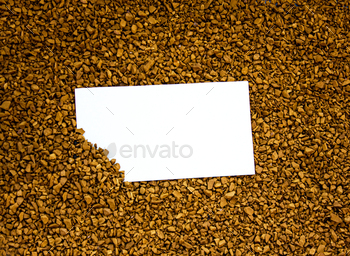 Instant coffee in granules with white card with place for text.