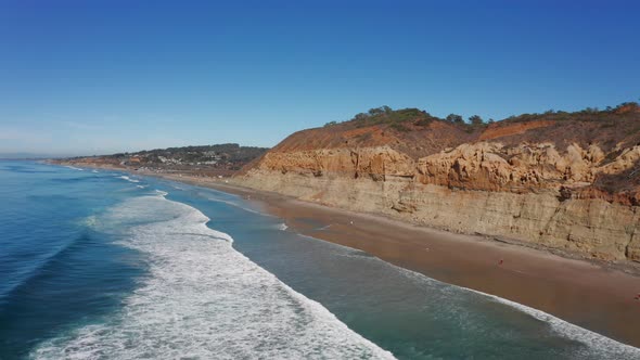 aerial view of ocean waves breaking on sandstone cliffs beach at Torrey Pines State Natural Reserve,