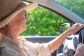 Senior woman driving car smiling - PhotoDune Item for Sale