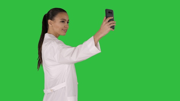 Stylish european doctor brunette taking selfie on phone