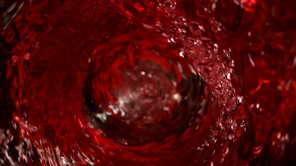 Super Slow Motion Shot of Red Wine Whirling in Glass Bottle at 1000Fps