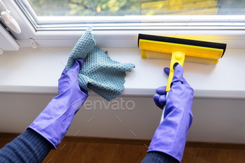 ple gloves holds a rag and a mop for cleaning windows