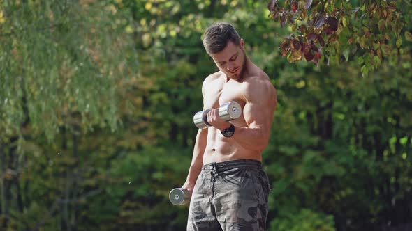 Man Training In Park. Healthy young man training outdoors in park