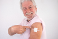 70-year-old Caucasian smiling man after receiving the booster of the covid-19 coronavirus vaccine - PhotoDune Item for Sale