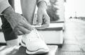 Close-up of woman's hands tying the laces of white sneakers. Activity, sport, fitness,runner concept - PhotoDune Item for Sale