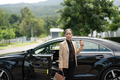 Asian mature woman disembarking the luxury car - PhotoDune Item for Sale