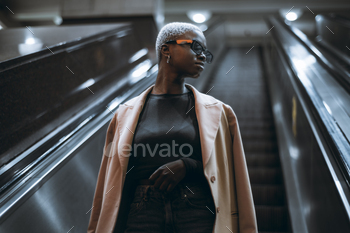 Afro girl on the metro escalator