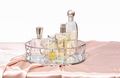 various bottles of perfume on a trendy mirror tray. female perfume set. fragrances for woman - PhotoDune Item for Sale