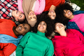 Happy young multi ethnic women having fun lying on park grass - Diversity and friendship concept - PhotoDune Item for Sale