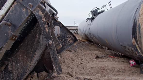 Panning the wreckage of train car tankers carrying flammable loads