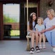 Smiling Grandmother with Granddaughters Sitting on Rope Swing - VideoHive Item for Sale
