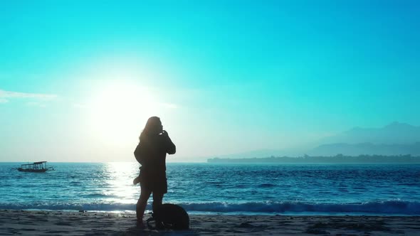 Single female enjoys life on paradise tourist beach journey by blue sea and white sand background of