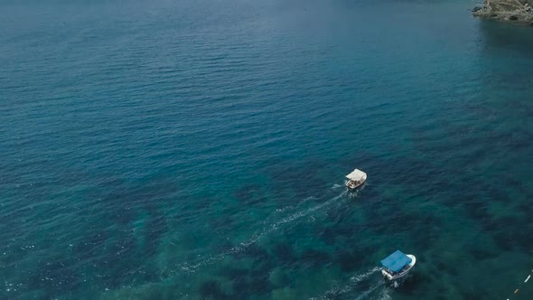 Aerial view of speedboats moving fast by sea on sunny day in Montenegro