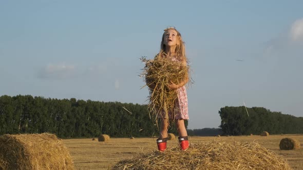 Cute Little Girl Having Fun on a Straw Bale