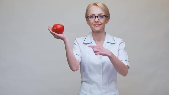 Nutritionist Doctor Healthy Lifestyle Concept - Holding Organic Red Apple