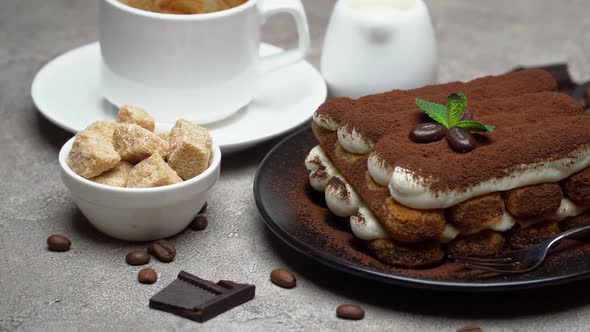 Classic Tiramisu Dessert, Cup of Coffee, Sugar and Milk on Concrete Background