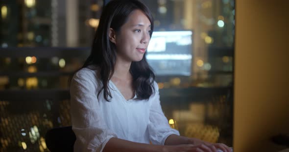 Woman work on computer at night