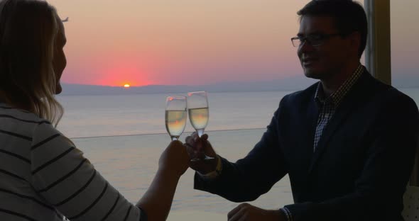 Loving couple enjoying romantic evening in seaside cafe